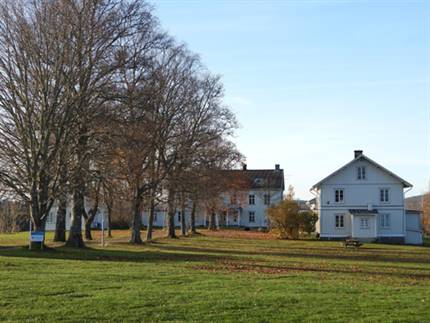 Bild på herrgårdsområdet med trädallé, herrgårdsbyggnad och annex